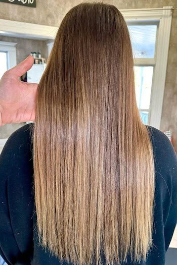 Warm Honey Brown With Subtle Highlights hair color on a woman with long straight brown hair, from back.