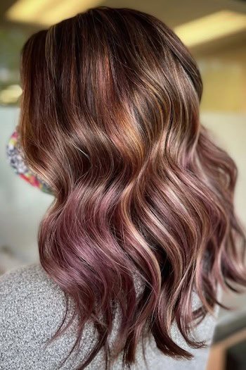 Brunette With Plum-Purple Highlights hair color on a woman with brown hair.