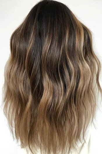 Brunette With Honey Blonde Ombre hair color on a woman with long brown hair, from back.