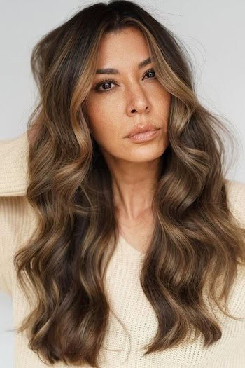 Warm Brown Hair With Caramel Blonde Balayage hair color on a woman with brown hair.