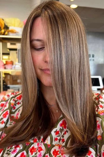 Light Brown Hair With Ash Blonde Highlights hair color on a woman with brown hair.