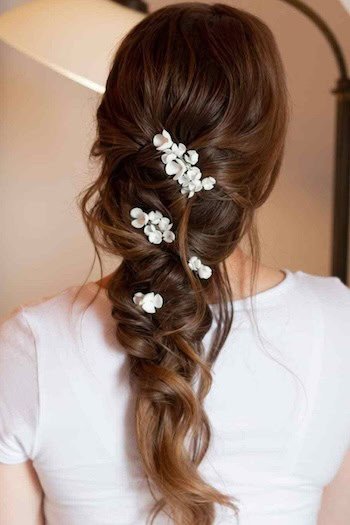 Chestnut Brown Twisted Braid With Floral Accents hair color on a woman with brown hair, from back.