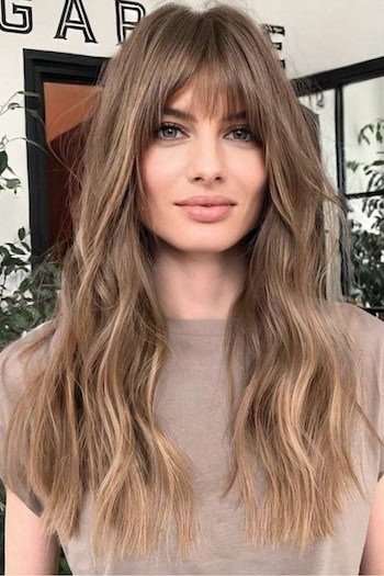 Light Ash Brown With Soft Blonde Highlights hair color on a woman with brown hair.